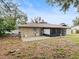 Tan house exterior with screened patio and backyard at 1018 Bear Lake Rd, Apopka, FL 32703