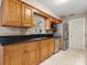 Kitchen boasts wood cabinets, granite countertops, and stainless steel appliances at 1018 Bear Lake Rd, Apopka, FL 32703