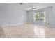 Bright living room with tile floors and large window at 1018 Bear Lake Rd, Apopka, FL 32703