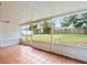 Screened porch with tiled floor and view of backyard at 1018 Bear Lake Rd, Apopka, FL 32703