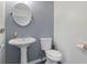 Clean and simple bathroom with pedestal sink and toilet at 1030 Bel Aire Dr, Daytona Beach, FL 32118