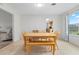 Dining area with wood table and bench seating, adjacent to kitchen at 1030 Bel Aire Dr, Daytona Beach, FL 32118