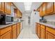 View of kitchen with granite countertops and wooden cabinets at 1030 Bel Aire Dr, Daytona Beach, FL 32118