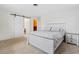 Main bedroom with carpeted floor, barn door, and ensuite bathroom at 1030 Bel Aire Dr, Daytona Beach, FL 32118