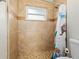 Shower stall with beige tile and a sea-themed shower curtain at 1030 Bel Aire Dr, Daytona Beach, FL 32118