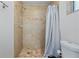 Shower stall with beige tile and a simple shower curtain at 1030 Bel Aire Dr, Daytona Beach, FL 32118