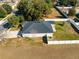 Aerial view of a house with a fenced backyard and driveway at 108 Alexandria Cir, Deland, FL 32724