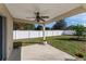 Covered patio with ceiling fan, overlooking fenced backyard at 108 Alexandria Cir, Deland, FL 32724