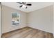 Simple bedroom with wood flooring and window at 108 Alexandria Cir, Deland, FL 32724