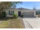 One-story home with gray siding, blue shutters, and landscaped yard at 108 Alexandria Cir, Deland, FL 32724