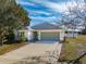 Charming one-story house with gray garage door at 108 Alexandria Cir, Deland, FL 32724