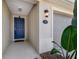 Blue front door with walkway and landscaping at 108 Alexandria Cir, Deland, FL 32724