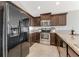 Kitchen with dark wood cabinets, granite counters, and black appliances at 108 Alexandria Cir, Deland, FL 32724