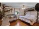 Spacious bedroom with a king-size bed, crib, and wood floors at 117 Temple St, Deland, FL 32720