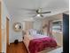 Light and airy bedroom with a full-size bed and wood floors at 117 Temple St, Deland, FL 32720