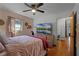 Cozy bedroom with a queen-size bed and large TV at 117 Temple St, Deland, FL 32720