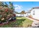 Spacious side yard with blooming flowers and vehicles at 117 Temple St, Deland, FL 32720