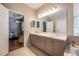 Elegant bathroom with dual vanity, quartz countertop, and view of bedroom at 14020 Bradbury Rd, Orlando, FL 32828