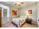 Charming bedroom with floral bedding and a window with sheer curtains at 14020 Bradbury Rd, Orlando, FL 32828