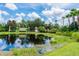 Community entrance with a pond and lush landscaping at 14020 Bradbury Rd, Orlando, FL 32828