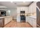 Kitchen with white cabinets, stainless steel appliances, and tile floor at 14020 Bradbury Rd, Orlando, FL 32828