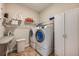 Well-equipped laundry room with washer, dryer, and storage shelves at 14020 Bradbury Rd, Orlando, FL 32828