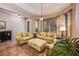 Bright living room with light green couches and patterned ottoman at 14020 Bradbury Rd, Orlando, FL 32828