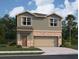 Two-story house with a two-car garage, stone accents and landscaping at 1433 Dalkeith Cv, Sanford, FL 32771