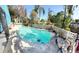 Refreshing blue swimming pool with surrounding landscaping at 154 Woodbury Pines Cir, Orlando, FL 32828