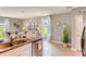 Kitchen island with granite countertop and double sink, looking toward the living room at 1589 Bull Hill Rd, Kissimmee, FL 34744