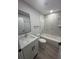 Modern bathroom with white vanity, marble shower, and grey vinyl flooring at 1590 West Pkwy, Deland, FL 32724