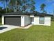 Newly constructed home with a two-car garage and well-manicured lawn at 1590 West Pkwy, Deland, FL 32724