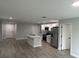 Open concept kitchen with island, stainless steel appliances and grey vinyl flooring at 1590 West Pkwy, Deland, FL 32724