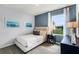 Well-lit bedroom with neutral-toned furniture and blue accent wall at 1601 Bull Hill Rd, Kissimmee, FL 34744