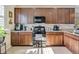 Modern kitchen with dark wood cabinets and granite countertops at 161 Old Moss Cir, Deland, FL 32724