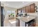 Modern kitchen with dark wood cabinets and granite countertops at 161 Old Moss Cir, Deland, FL 32724