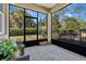 Relaxing screened patio with pavers and lush landscaping at 161 Old Moss Cir, Deland, FL 32724