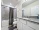 Bathroom with granite countertop and gray tile shower at 1623 Aspen Ave, Davenport, FL 33837