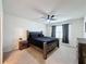 Bedroom with dark wood bed frame and ceiling fan at 1623 Aspen Ave, Davenport, FL 33837