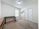 Bright bedroom with carpeted floor, built-in desk, and double door closet at 1623 Aspen Ave, Davenport, FL 33837