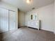 Bedroom with white dresser and double door closet at 1623 Aspen Ave, Davenport, FL 33837