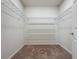 Walk in closet with wire shelving and neutral carpet at 1623 Aspen Ave, Davenport, FL 33837