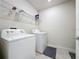 Laundry room with washer, dryer, and overhead shelving at 1623 Aspen Ave, Davenport, FL 33837