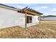 Backyard patio with wooden pergola and sliding glass door at 17902 Sw 39Th Ct, Ocala, FL 34473