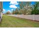 Spacious backyard with a stone wall and lush lawn at 190 Mitchell Creek Way, Oviedo, FL 32765