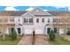 Two-story townhouses with gray siding, blue doors, and paved driveways at 190 Mitchell Creek Way, Oviedo, FL 32765