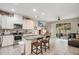 Open concept kitchen with island, white cabinets, and granite countertops at 190 Mitchell Creek Way, Oviedo, FL 32765