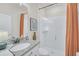 Bathroom with shower, granite vanity, and orange accents at 2102 Gopher Tortoise Ter, Oakland, FL 34787