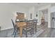 Dining room with wooden table, black chairs, and area rug at 2102 Gopher Tortoise Ter, Oakland, FL 34787