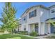 Two-story townhome with light blue siding, landscaping, and a welcoming front porch at 2102 Gopher Tortoise Ter, Oakland, FL 34787